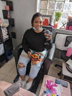 Nail Flavor client enjoying wine while being serviced