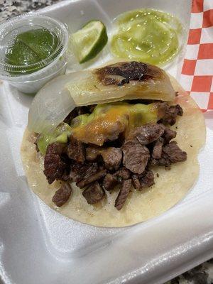 Asada taco with grilled white onion and salsa.