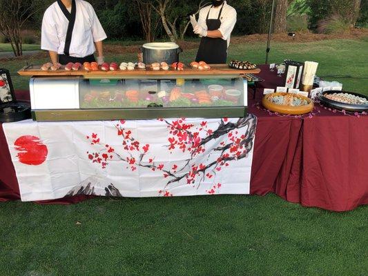 Outdoor golf event with live sushi bar