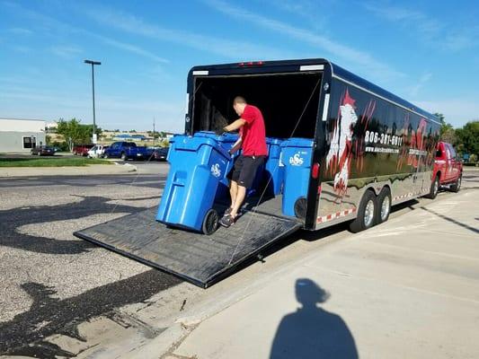 Paco is loading bins full of paper in his trailer to take to DSS for shredding.