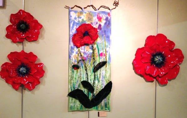 Poppy in two mediums, ceramic and textile collage.