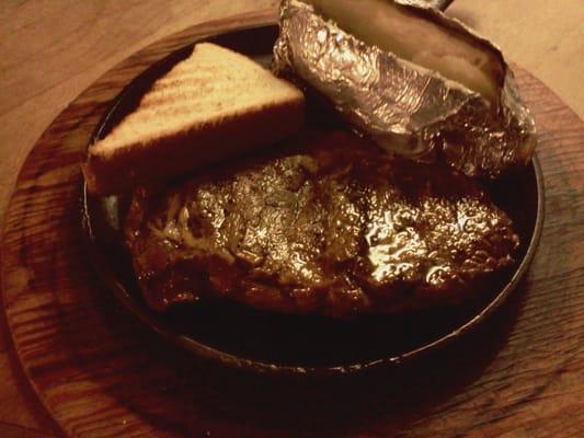 Ribeye and baked potato with Texas toast.