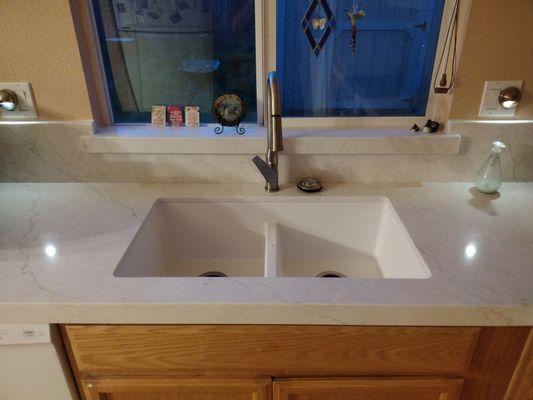 Lovely quartz with brushed nickel faucet.