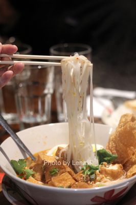 Thai Style Tom Yum Noodle Soup with Tofu ($16.95) - spicy Thai style soup w rice noodles, peanut, crispy wonton skin, hard boiled egg