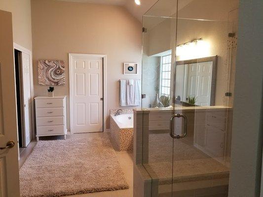 Columns were removed and replaced with wall and pocket door. Garden tub surround was retiled with travertine and glass ceramic.