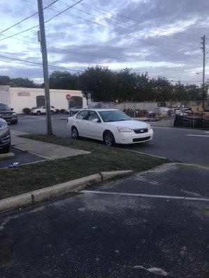 Entrance to the parking area.  No towing sign in sight.