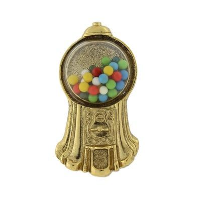 An antiqued gold-tone gumball machine brooch, inspired by the 1920's classic gumball machine. Available at www.1928.com.