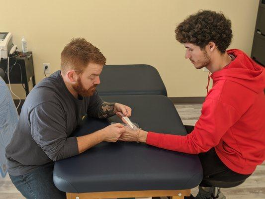 Ryan Hogan, OT works with a patient in our Wilmington clinic