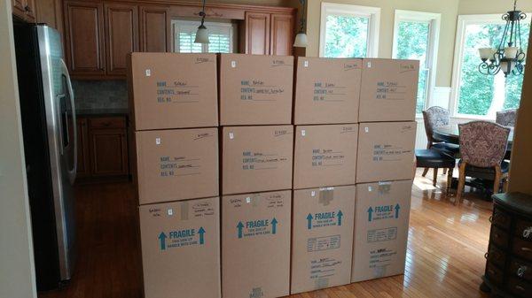 The kitchen is packed with boxes stacked neatly and ready to be moved.