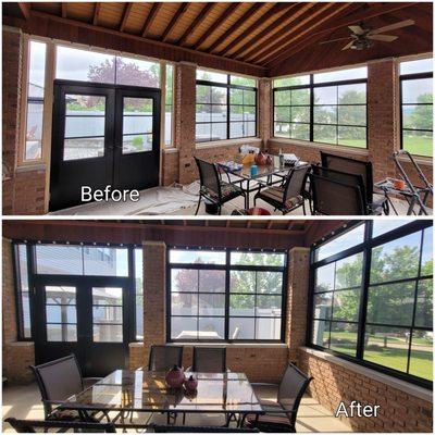 Enclosed patio with black framed aluminum windows & doors and black trim.