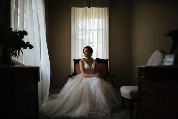 Bride looks out the window  | JTobiason Photography