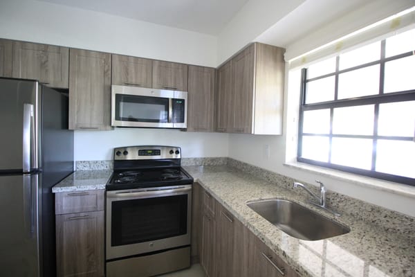 Brand new kitchen with stainless steel appliances and granite countertops.