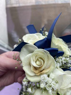 White roses corsage with blue ribbon