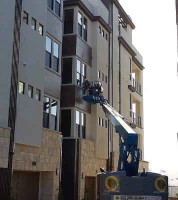 Boom work on this Newly developed 12 unit condominium complex. Making sure the windows are spotless. Safety First boom truck certified