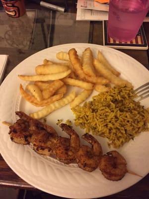 (Put onto plate at home for eating) grilled lemon pepper shrimp, fries, rice