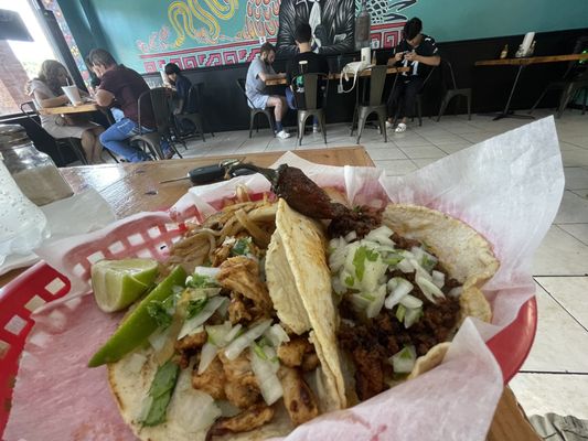 Chicken and steak taco on corn shell. Tasty.