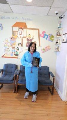 Dr. Veena Puri holding a 40 Year service plaque presented to her by Washington Hospital Medical Staff