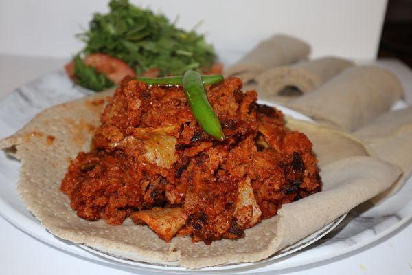 Beef Kwanta Firfir-
Dry cooked beef, onions, Jalapeno, tomatoes, berbere, & butter