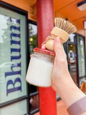 Salon quality hair conditioner in a reusable glass jar and a bamboo dish brush