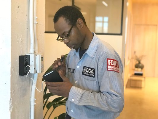 DGA technician installing an access control reader