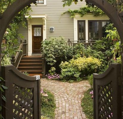 The front entrance to the cottage takes you under the front building to a beautiful garden.