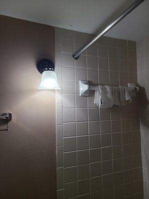 This is not a waterproof, bathroom safe sconce.  They do exist, why hasn't the hotel changed the fixture to something more safe?