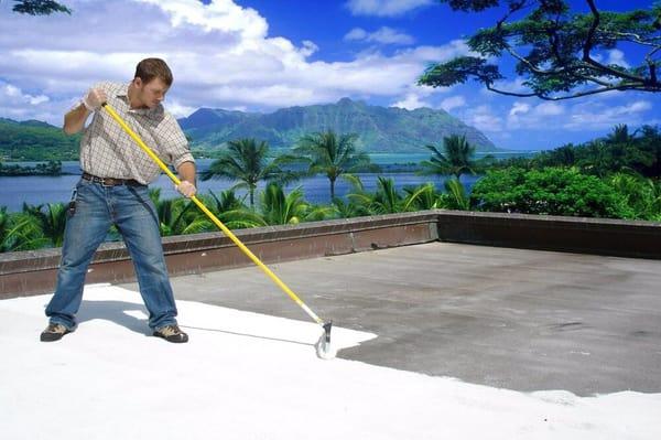 Silicone coating over a cap sheet roof.