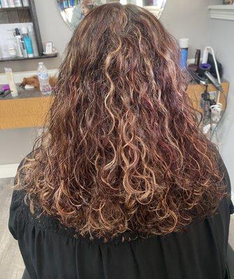 Chunky red and caramel highlights and low lights on curly hair