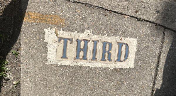 New Orleans does not have street signs. Street names are marked on walkway pavement intersections.