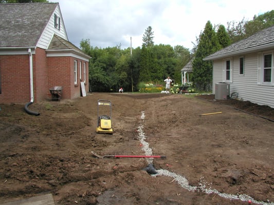 Creation of a shared swale with a drain tile system.