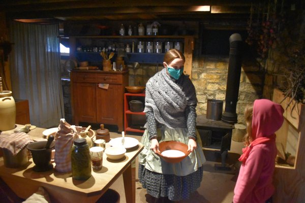 Staff members in period clothing engage visitors to help them understand what life was like in Kansas during the 1860s.