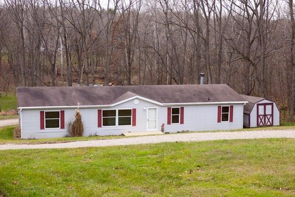 Snug country home on 4 acres. Wooded lot with stream running across!