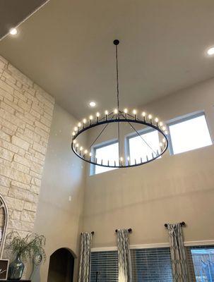 Install high ceiling chandelier