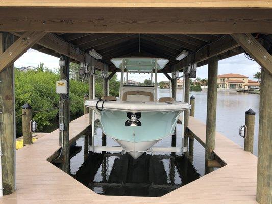 Covered Boat Lift, Trex Decking, Piling Mounted Dock Lighting, Black Piling Caps.