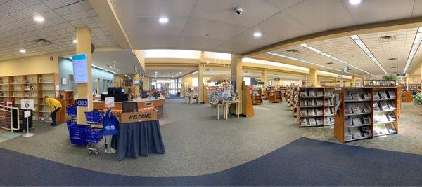 The inside of the library. Circ desk on the left, AV materials on the right, and all the books beyond.