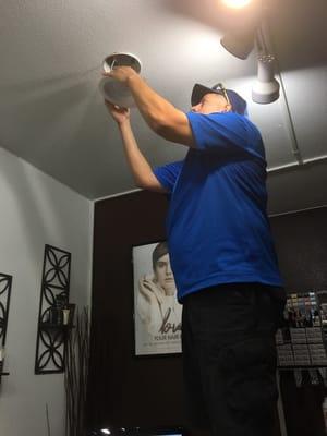 Installing LED retrofit kits in a salon to bring out a more natural and true light in their work stations.