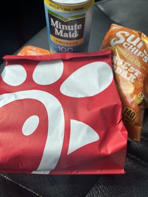 Spicy chick-fil-a sandwich, chips & a drink. Gotta add my zesty buffalo sauce.