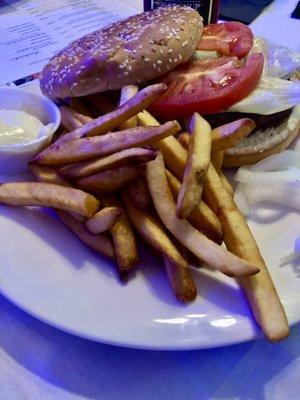 Grilled hamburger and crispy French fries.