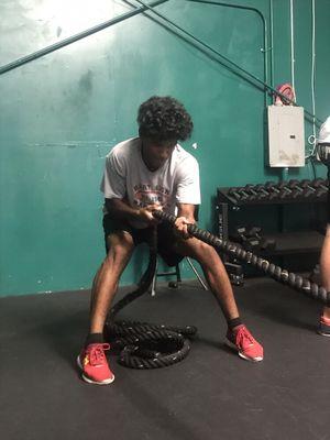 Hart athlete pulling a sled to develop a better posterior chain.