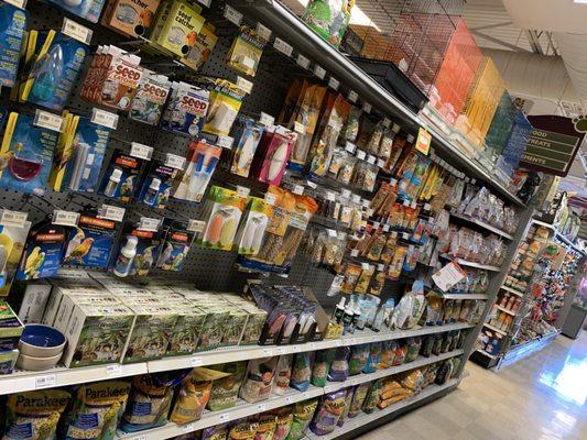 Opposite wall with bird food, treat and supplement products.