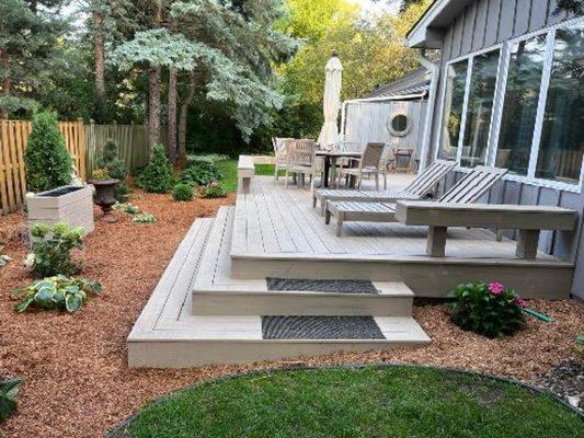 Custom designed deck with built in benches and custom wrap around steps