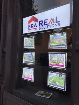 Some real estate opportunities posted in the window.