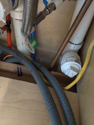 Hole in undersink cabinet.  Should have been fitted with filler board and veneer to hide it.