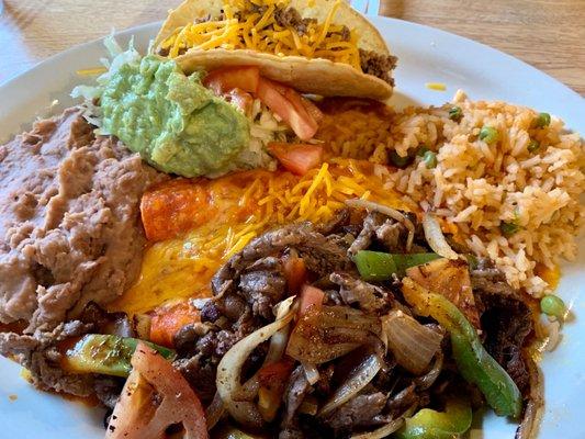 Combo #28 beef fajita combo plate with beef taco, cheese enchiladas, rice and beans, guacamole salad