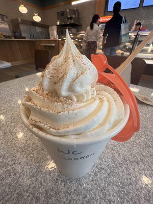 Latte with whipped cream and cinnamon topping