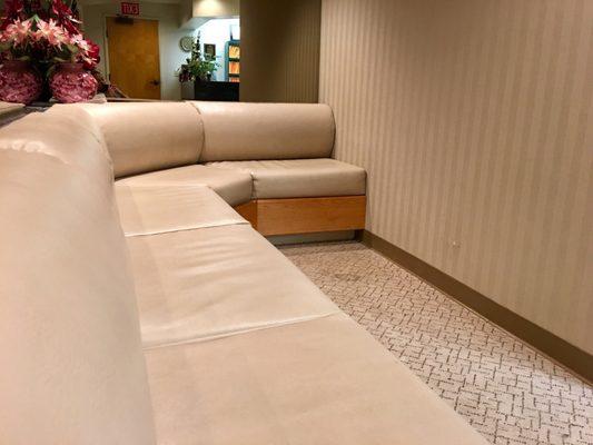 Waiting area & reception desk in the mirror reflection.  It's never filled because they're always on time! - VN