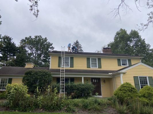 Men working on replacing shingles