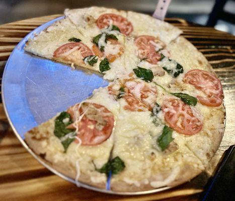 Blanco pizza- Roasted Garlic Sauce, Grilled Italian Marinated Chicken, Tomatoes, Spinach, and Asiago Cheese