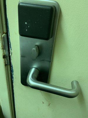 Dirty door handle from inside the room. Dead bolt is hard to turn