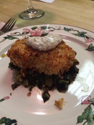 Breaded cod over fresh collars greens.